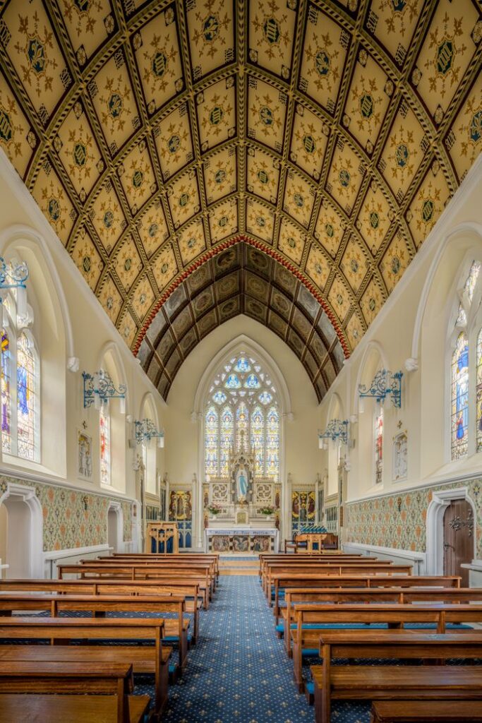 Stunning view of a Gothic chapel with decorative ceiling and stained glass windows in England.